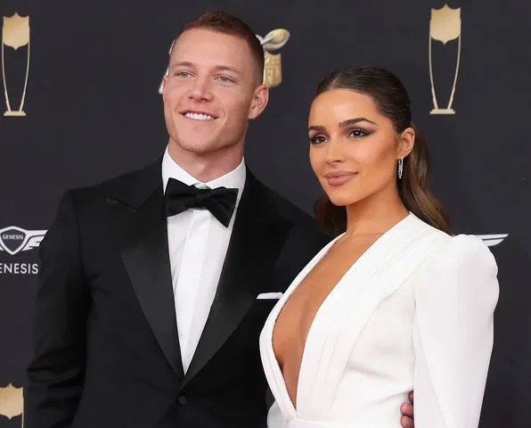 Christian McCaffrey and Olivia Culpo on the red carpet at the NFL Honors